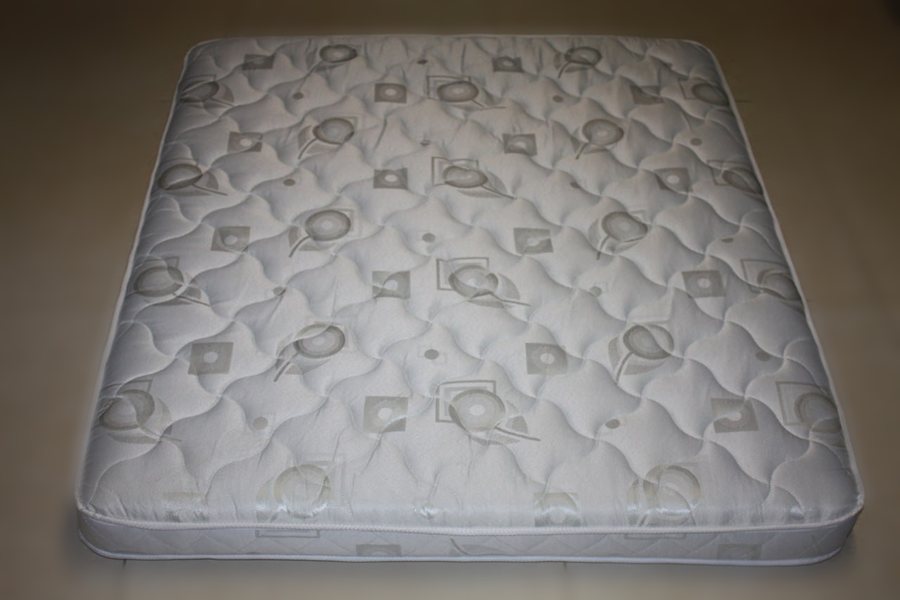 Top view of an empty quilted dog mattress showing the full quilted cover